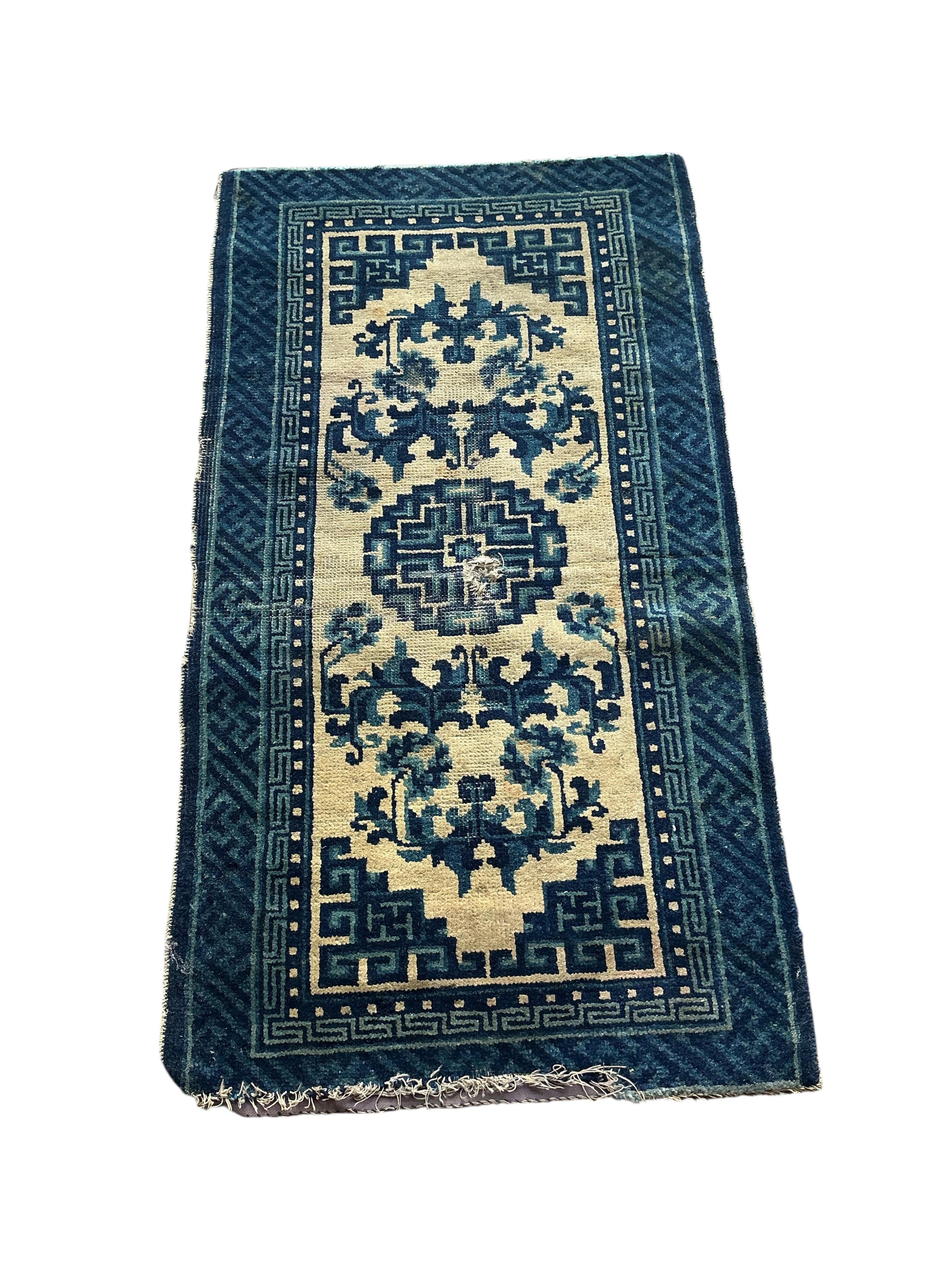 Two Sino-Tibetan ivory ground rugs, 19th century and two Tibetan ivory ground square mats, largest 120 x 66cm